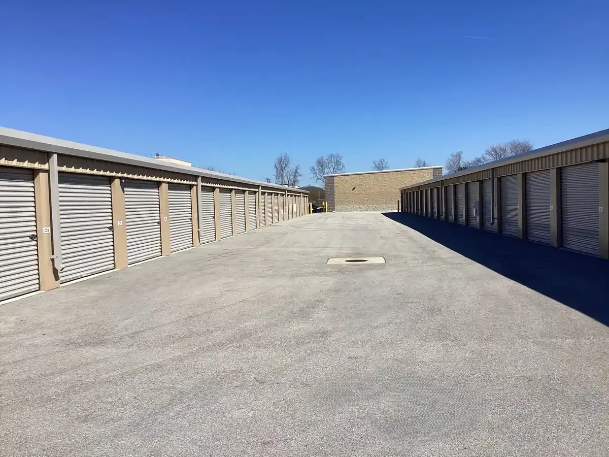 Wide driveway with drive up units and roll up doors. 